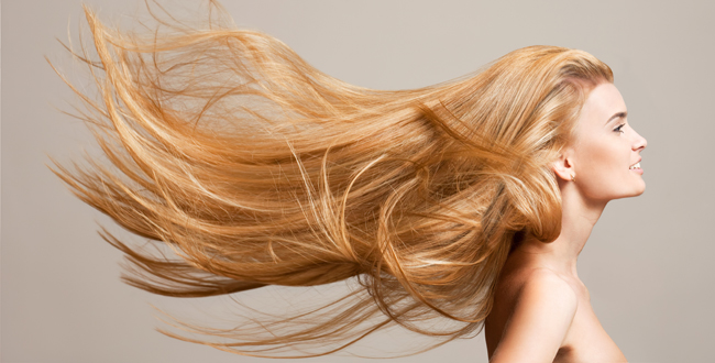 Portrait of a beautiful young blond woman with amazing flowing hair.